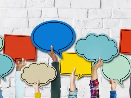several arms holding up speech bubbles