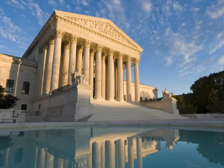 The front of the US Supreme Court in Washington, DC, at dusk.