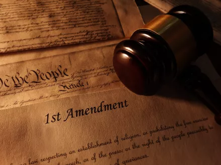 First Amendment and US Constitution historic documents with legal gavel