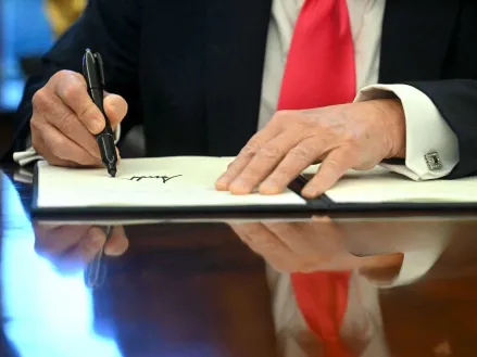 US President Donald Trump signs an Executive Order at the Oval Office of the White House in Washington, DC on February 25, 2025