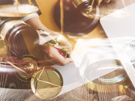 Contract papers with brass scale on desk in office justice and law concept picture with film grain effect.jpg