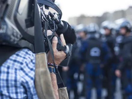 News cameraman films police on the streets