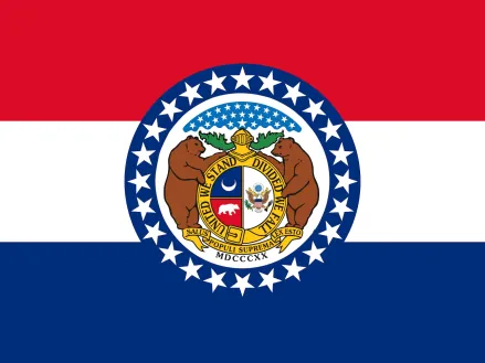 Flag of the state of Missouri: A horizontal tricolor of red, white, and blue, with the arms from the Great Seal of Missouri centered on the three bands. The Seal is bordered by a wide band of blue with 24 white stars