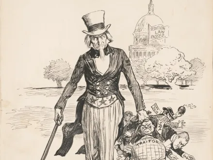 Drawing shows Uncle Sam rounding-up men labeled "Spy," "Traitor," "IWW," "Germ[an] money," and "Sinn Fein" with the United States Capitol in the background displaying a flag that states "Sedition law passed" referring to the Sedition Act of 1918.