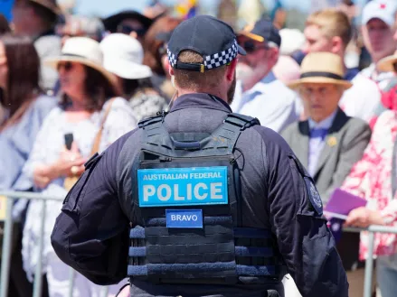 A Canberra police officer standing in front of a crowd