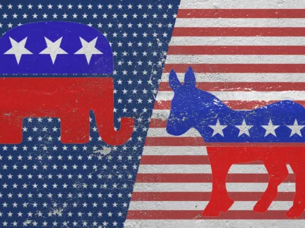 Red elephant symbol of the Republican Party and the blue donkey symbol of the Democratic Party against the background of the American flag pattern (Image via Shutterstock.com