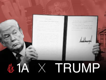 Donald Trump holding up an executive order with his signature.