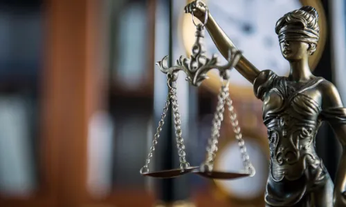Law and Justice concept with gavel and scale in background in court library