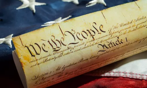 US Constitution and American Flag representing freedom of speech