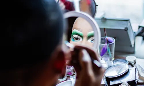 Drag performer putting on makeup