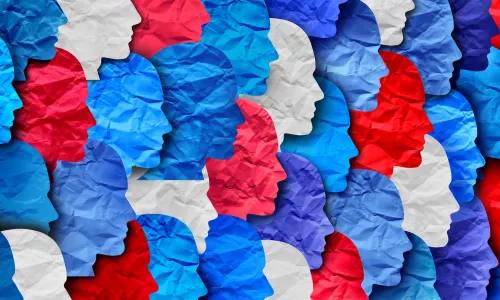 shapes of human heads cut out of wrinkled paper red white and blue