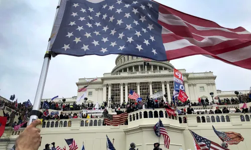 An upside down American flag waves as pro-Trump protestors took over the steps of the Capital in Washington, DC, Wednesday, January 6, 2021 Capitol Takeover