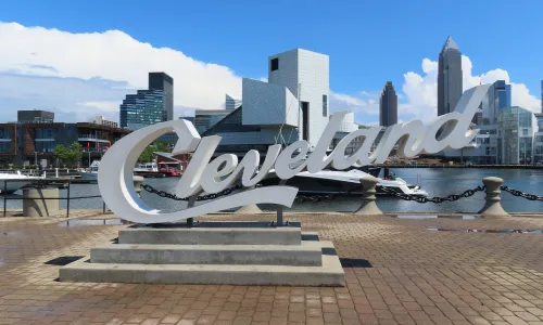 Large Cleveland sign with city skyline in background