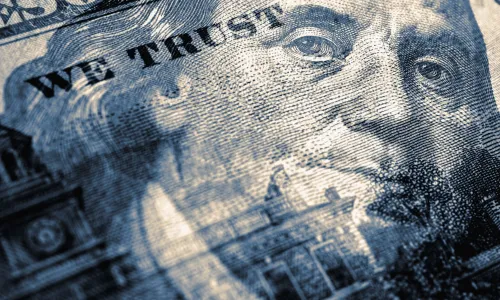 Hundred dollar bill with portrait of Benjamin Franklin in focus Blue tinted illustration