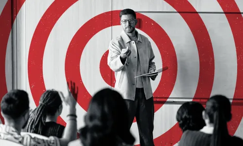 Graphic showing a black and white photo of a teacher at the front of a classroom filled with students with a red bullseye target over the teacher