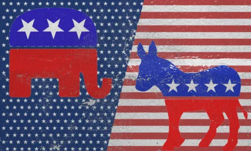 Red elephant symbol of the Republican Party and the blue donkey symbol of the Democratic Party against the background of the American flag pattern (Image via Shutterstock.com