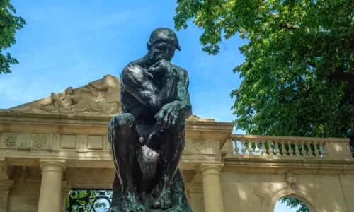 Thinker statue up close on a sunny day at the Rodin Museum in Philadelphia. (Image via Shutterstock.com)