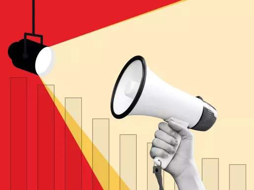 Person holding a megaphone up to a spotlight