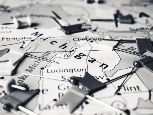 Map of the state of Michigan covered in little flag pins