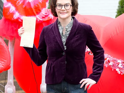 FIRE client Alexis Luttrell holding a copy of the citation from the City of Germantown