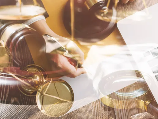 Contract papers with brass scale on desk in office justice and law concept picture with film grain effect.jpg