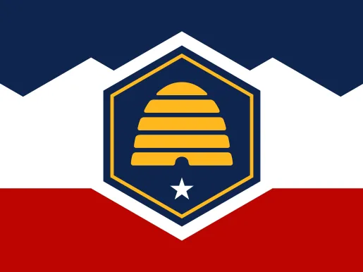 New flag for the state of Utah: Rectangle divided into three sections by two lines, with blue on top, white in the middle housing a blue hexagon outlined in gold with a gold beehive inside, a white five-pointed star below, and red at the bottom.