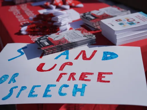FIRE table at University of Illinois Urbana Champaign with a sign on the corner that reads "stand up for free speech"
