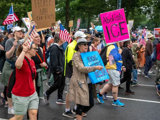 Protest in Center City, Philadelphia, with one person holding a pink sign that reads "Abolish Ice". Photo by Alejandro Diaz Manrique for Shutterstock.com