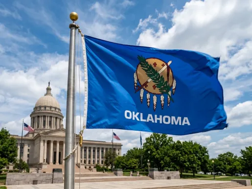 Oklahoma state flag in front of the capitol in Oklahoma City. (Image via Shutterstock.com)