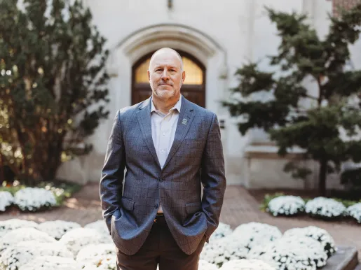 FIRE plaintiff Michael Balow in a suit with his hands in his pockets on the MSU campus.