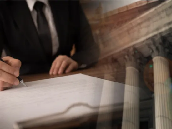 lawyer signing legal document and agreement with court building in background