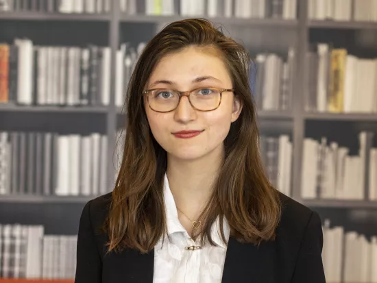 Photo of Emma Camp standing in FIRE's previous office 