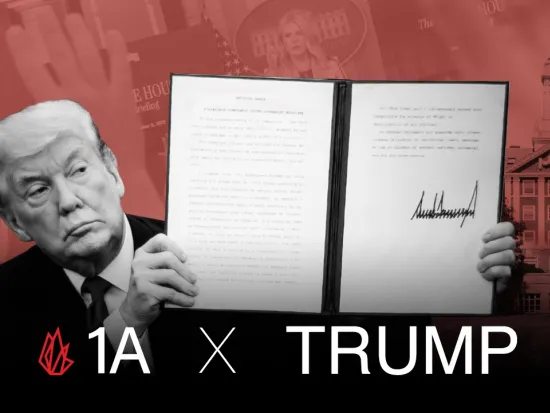 Donald Trump holding up an executive order with his signature.