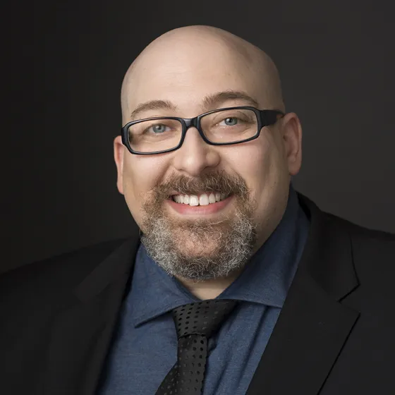 Headshot of Adam Goldstein