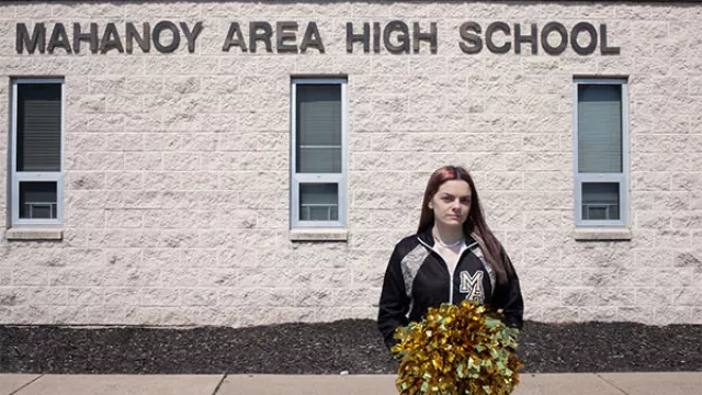 Brandi Levy stands before Mahanoy Area High School