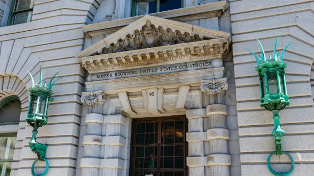 Ornate etrance to James R. Browning Courthouse flanked by large copper lanterns that have oxidized to light green