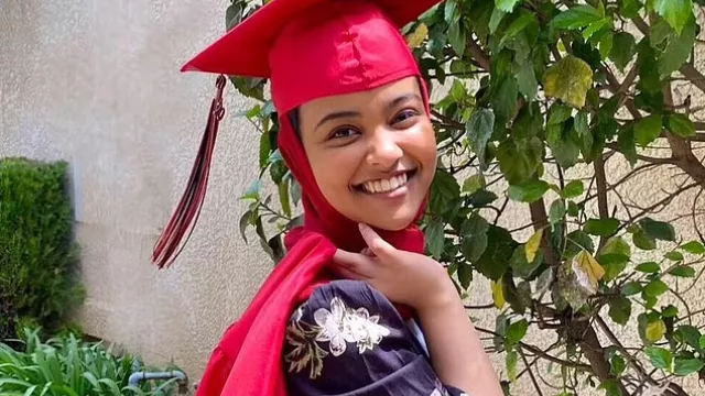 USC Valedictorian Asna Tabassum wearing a red graduation cap