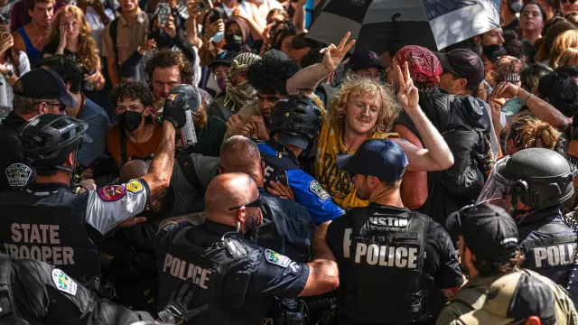 Protesters block police vehicles from leaving the University of Texas at Austin on Monday, April 29, 2024