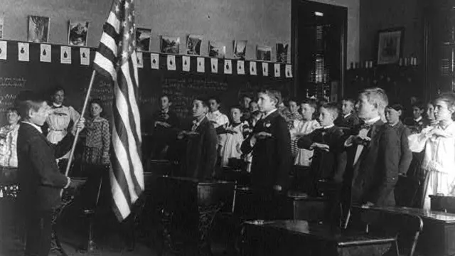 Group of children reciting pledge of allegiance to the flag in 1899