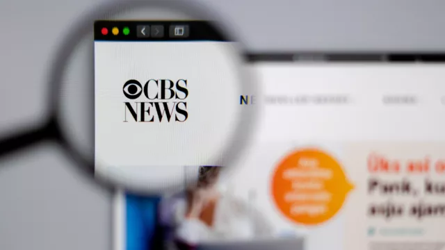 CBS logo visible through a magnifying glass