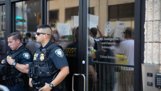 Protesters outside ICE offices, two police officers outside