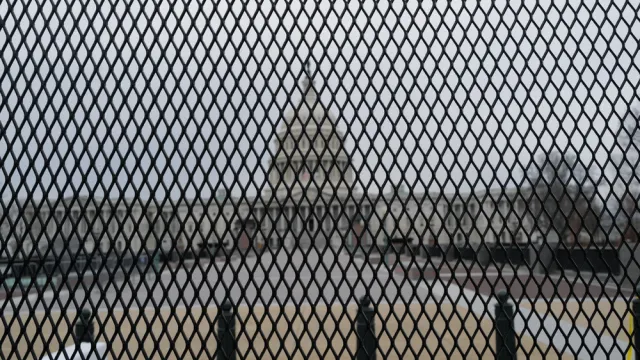 Capitol building as seen through security fence