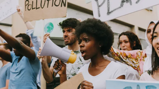student protesters holding bullhorns and signs