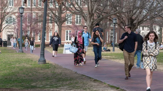 College students walk across the campus of UNC-Chapel Hill.