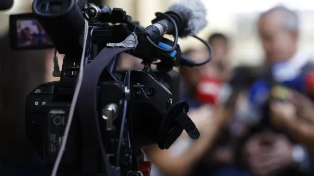 Image of a camera during a press conference